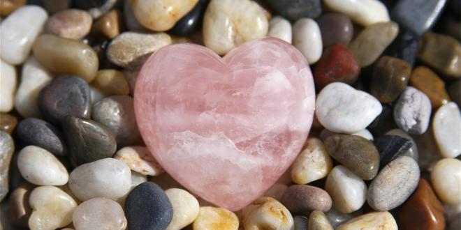 a pebble rock garden with a rose quartz heart