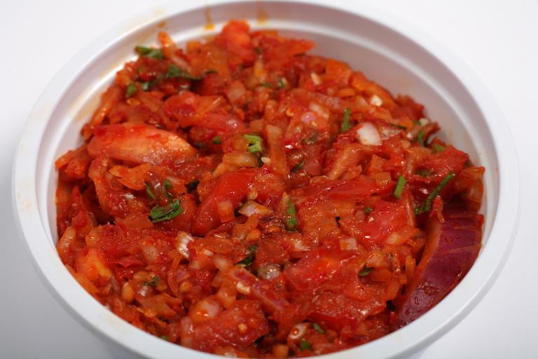 a bowl of blended tomatoes, shallot, and peppers