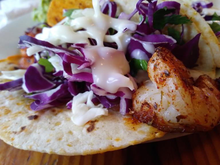 grilled shrimp on a tortilla with red cabbage and greek yogurt